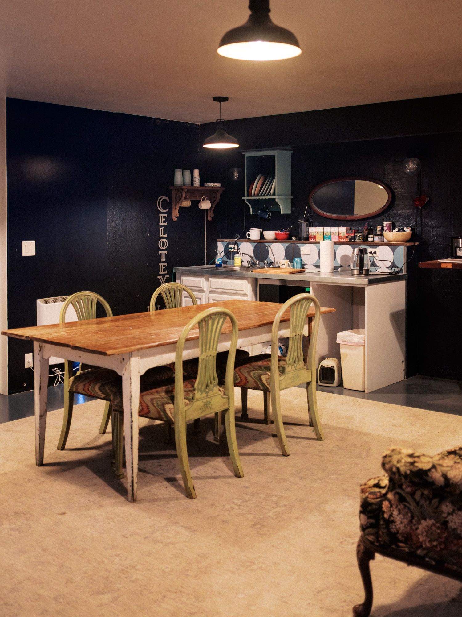 The shared breakroom with a farmhouse table and kitchenette