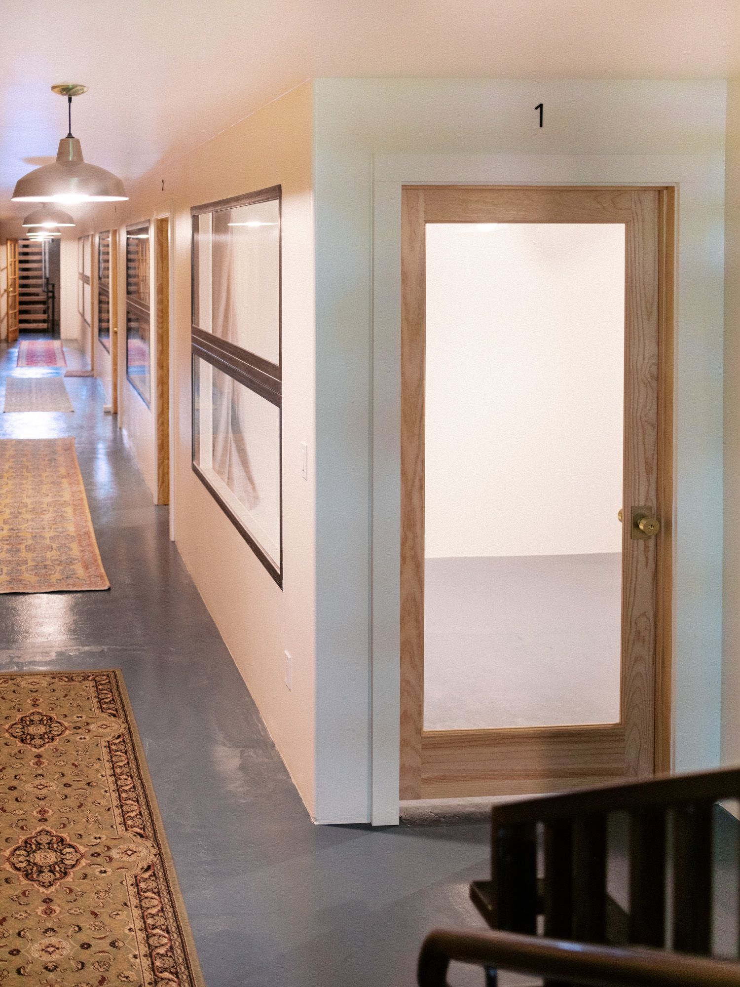 The lower-level hallway with numbered office doors